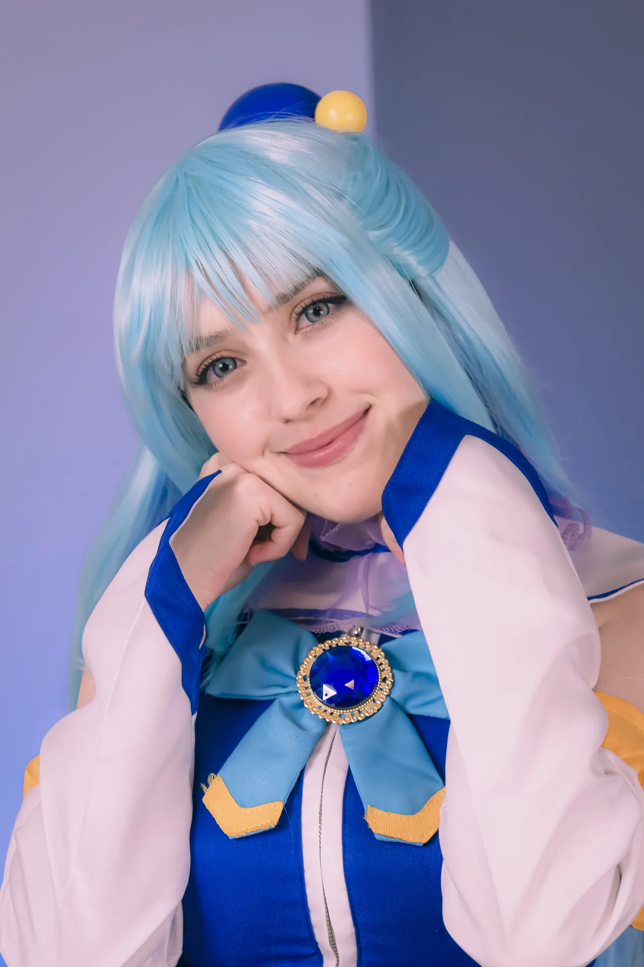 stelarhoshi aqua konosuba cosplay face close up, blue wig and gem brooch